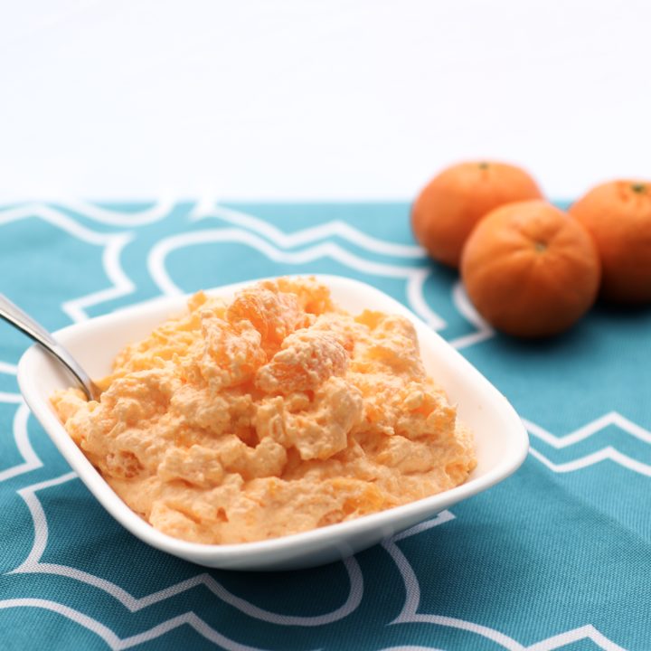 Creamy Orange Dreamsicle Dessert | Orange Creamsicle | Orange Dessert | Creamsicle Recipe | Orange Fluff | Orange Fluff Recipe | Fluffy Orange Dessert | No Bake Recipe | This Creamy Orange Dreamsicle Dessert is such a yummy and easy dessert! It's great for any summer get-together . . . and it doesn't require any baking! Find the recipe at SixCleverSisters.com