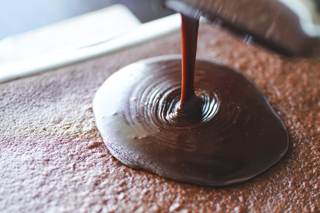 Sheet cake topped with glossy old fashioned chocolate fudge icing made with cocoa and Coca Cola, a dairy-free chocolate frosting.