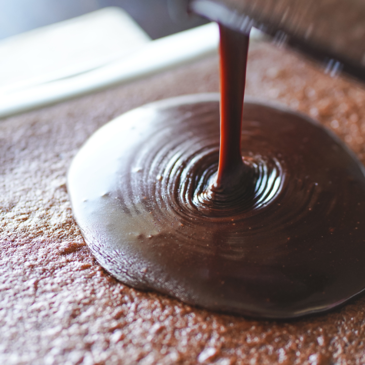 Sheet cake topped with glossy old fashioned chocolate fudge icing made with cocoa and Coca Cola, a dairy-free chocolate frosting.