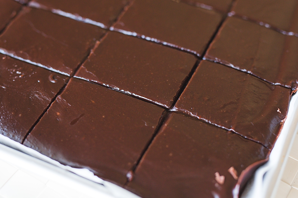 Sheet cake topped with glossy old fashioned chocolate fudge icing made with cocoa and Coca Cola, a dairy-free chocolate frosting.