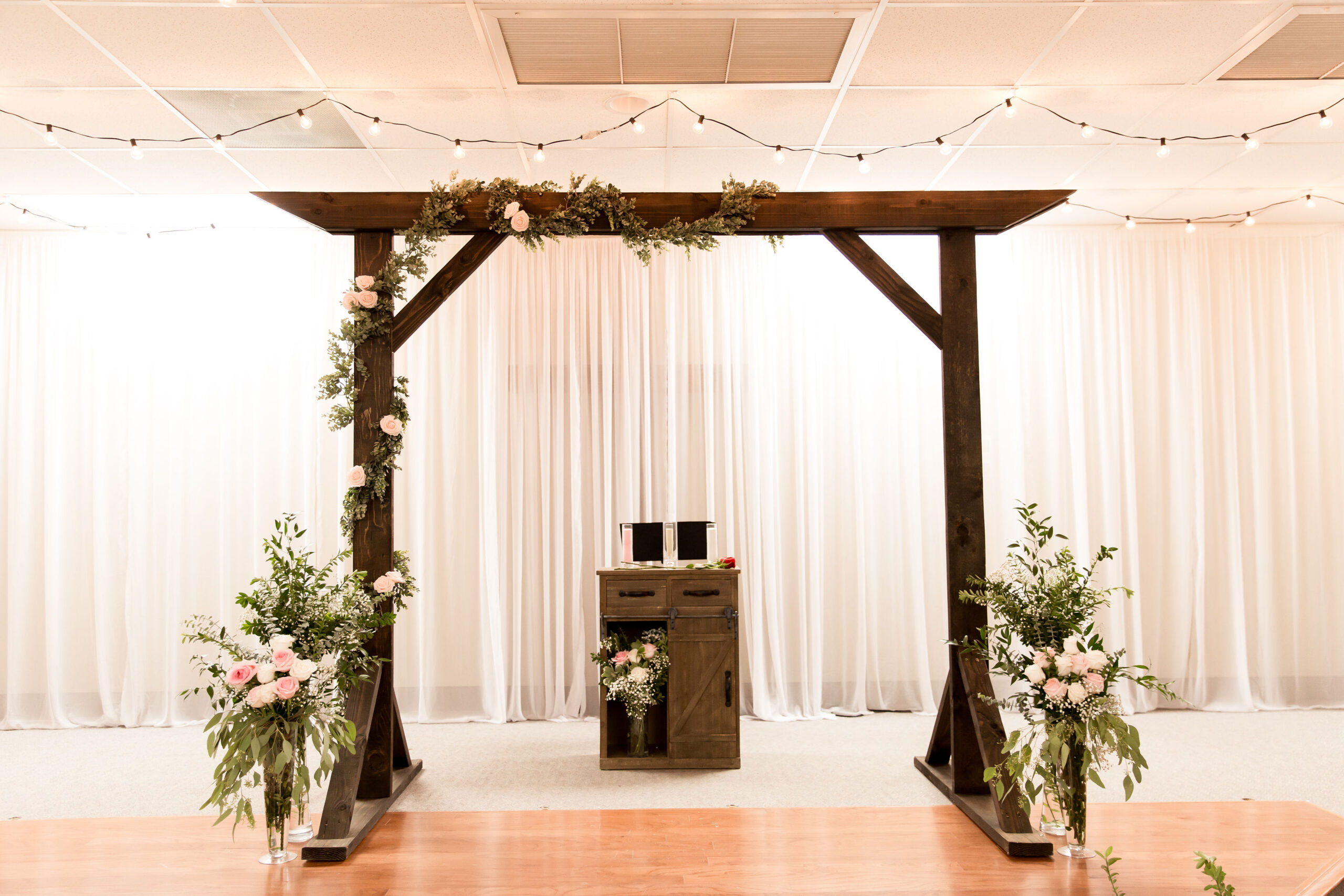 Wedding Arbor | Wedding Arch | Wedding Decor | Rustic Wedding | Wood Arbor | Wedding Ceremony Decor | Learn how to build these beautiful heavy duty arbor for a fraction of the price you would pay to buy one already made! Find the tutorial at SixCleverSisters.com