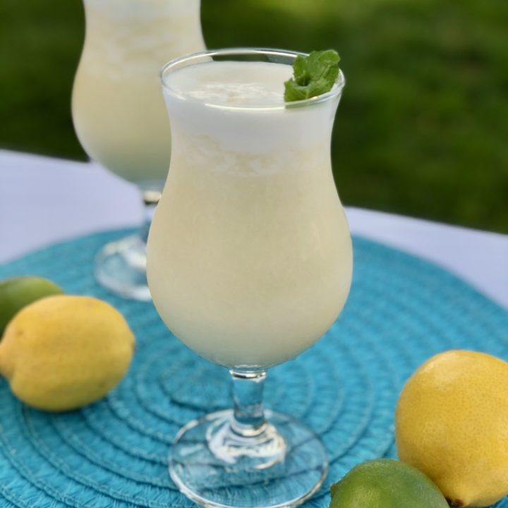 Tropical Drink | Summer Drink Recipe | Coconut Smoothie | Pineapple Drink | Fruity Drink | Drink Recipe | Easy Punch Recipe | Caribbean Breeze Drink | If you love tropical flavors and creamy sweet drinks, this Caribbean Breeze Drink is the recipe for you! Find it at SixCleverSisters.com.