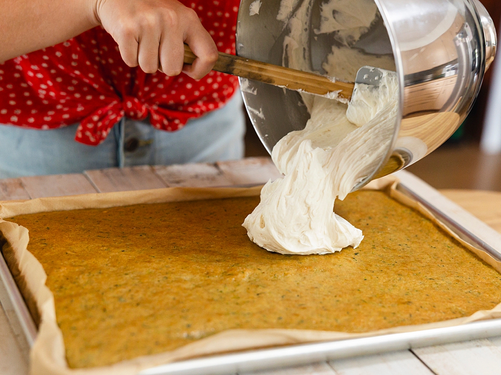 Moist zucchini sheet cake with cream cheese frosting, sliced and served as an easy zucchini dessert recipe.