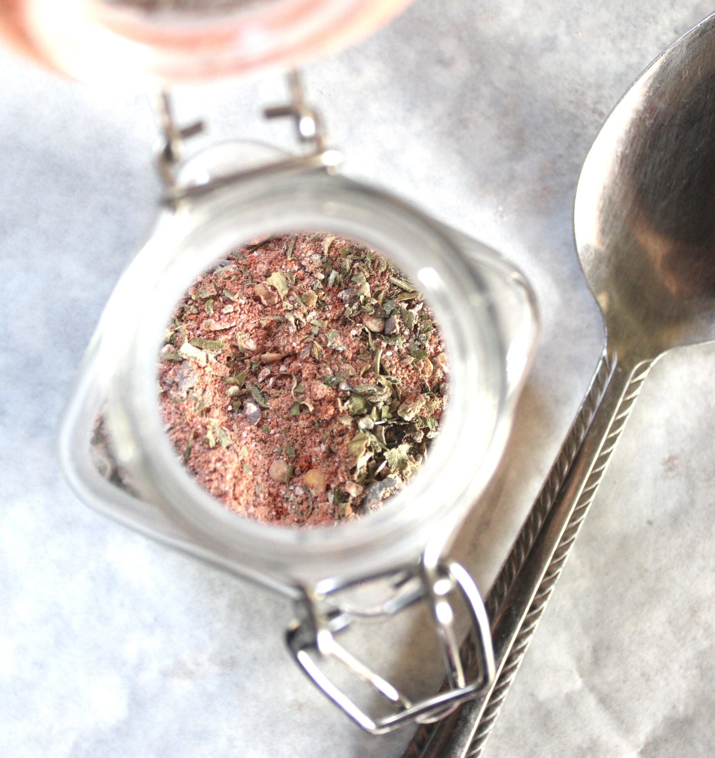 Glass mason jar filled with homemade steak rub stored in a cool dry place