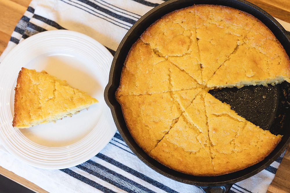 First bite of moist homemade-style Jiffy cornbread showing fluffy interior.