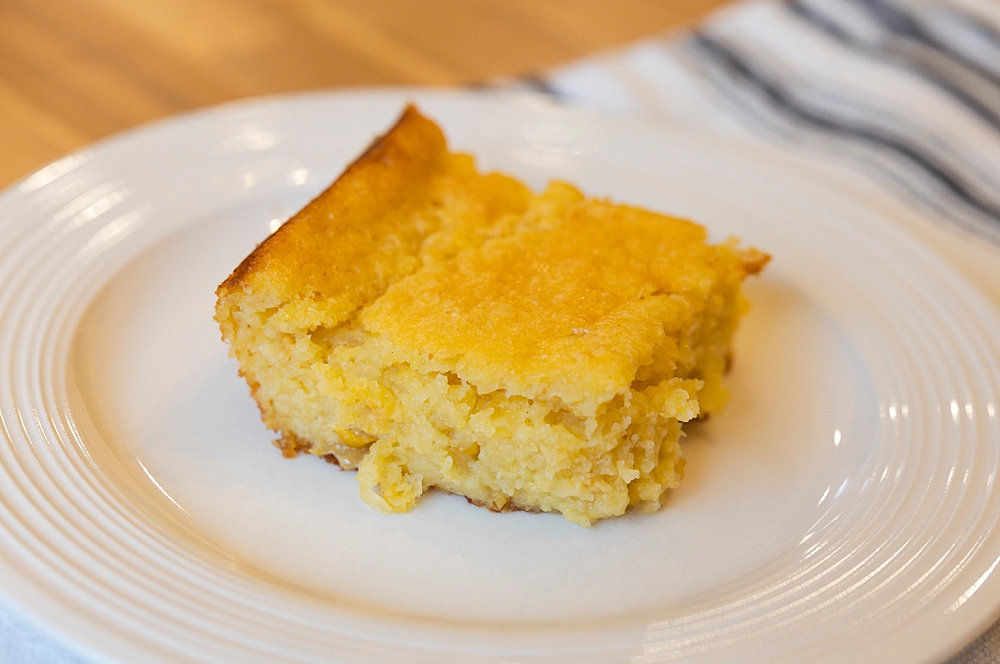 Warm slice of sweet cornbread topped made with Jiffy corn muffin mix hack