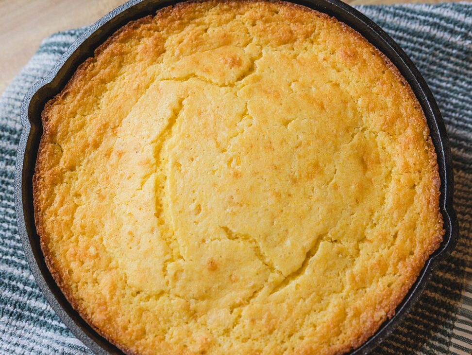 Ingredients for the easiest Jiffy corn muffin mix hack including Jiffy mix, sour cream, creamed corn, and melted butter.