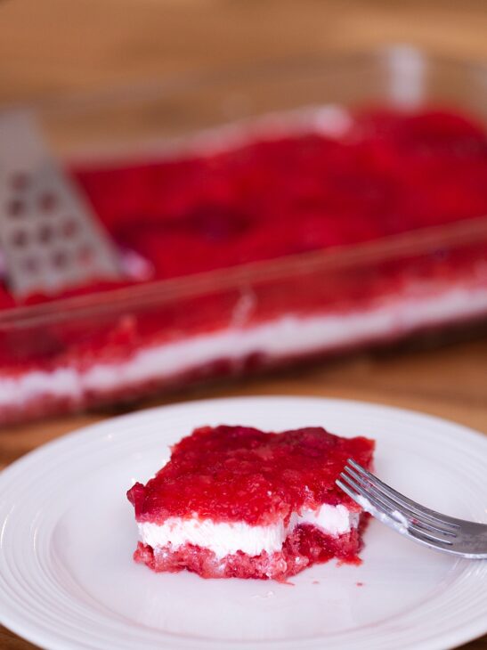 This creamy strawberry jello salad with frozen strawberries, pineapple, and a sour cream layer is a nostalgic, easy dessert perfect for potlucks and holidays.