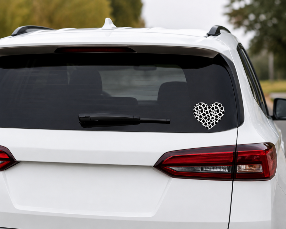 Cow print heart decal applied to a vehicle rear window