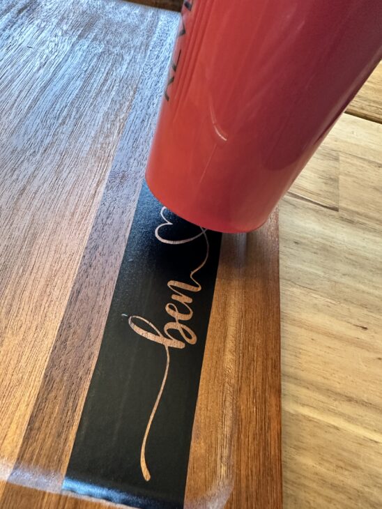 Personalized wooden charcuterie board with custom names created using a Cricut stencil, Applying a removable vinyl stencil to a wooden charcuterie board for a personalized gfit, How to make a personalized charcuterie board without engraving!