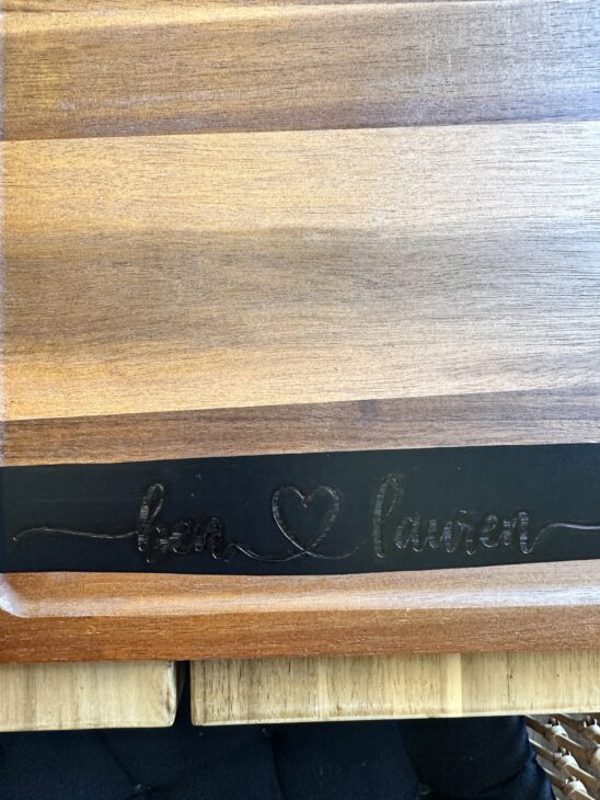 Personalized wooden charcuterie board with custom names created using a Cricut stencil, Applying a removable vinyl stencil to a wooden charcuterie board for a personalized gfit, How to make a personalized charcuterie board without engraving!