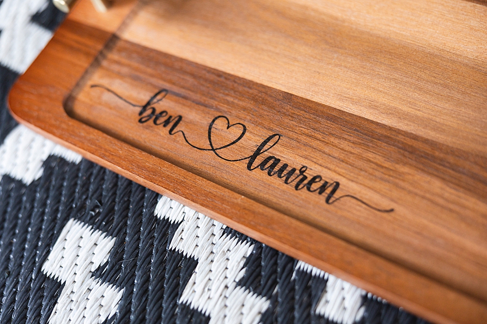 Personalized wooden charcuterie board with custom names created using a Cricut stencil, Applying a removable vinyl stencil to a wooden charcuterie board for a personalized gfit, How to make a personalized charcuterie board without engraving!